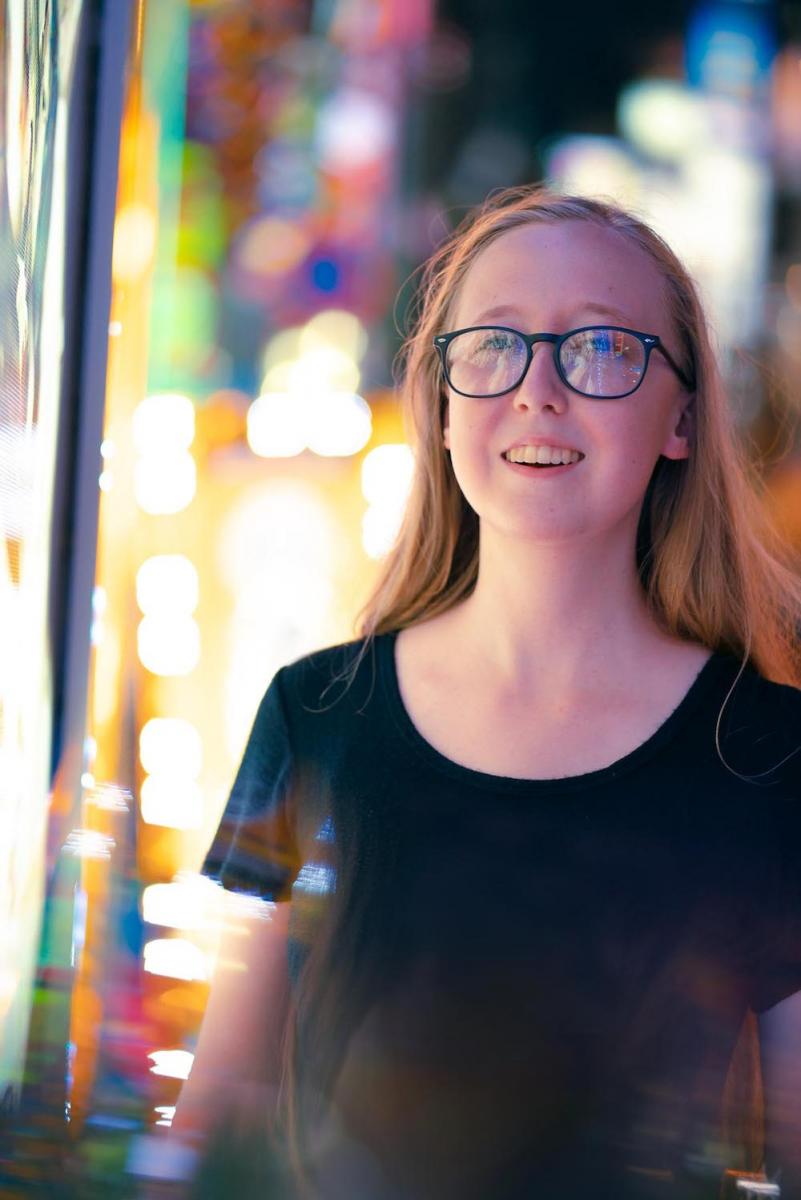 Marina Bydalek looks into lights on a city street - linguistics major