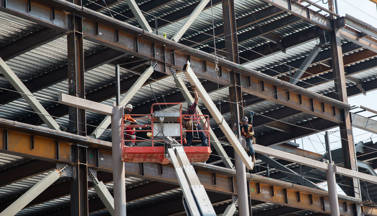 Steel crew installs a beam.