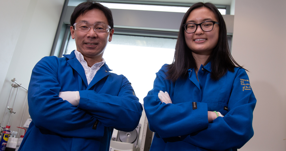 Joleen Cheah stands in a lab with her advisor.