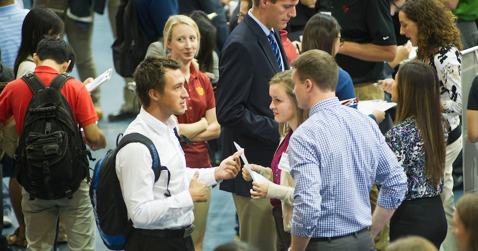 Students network inside a pavilion. 