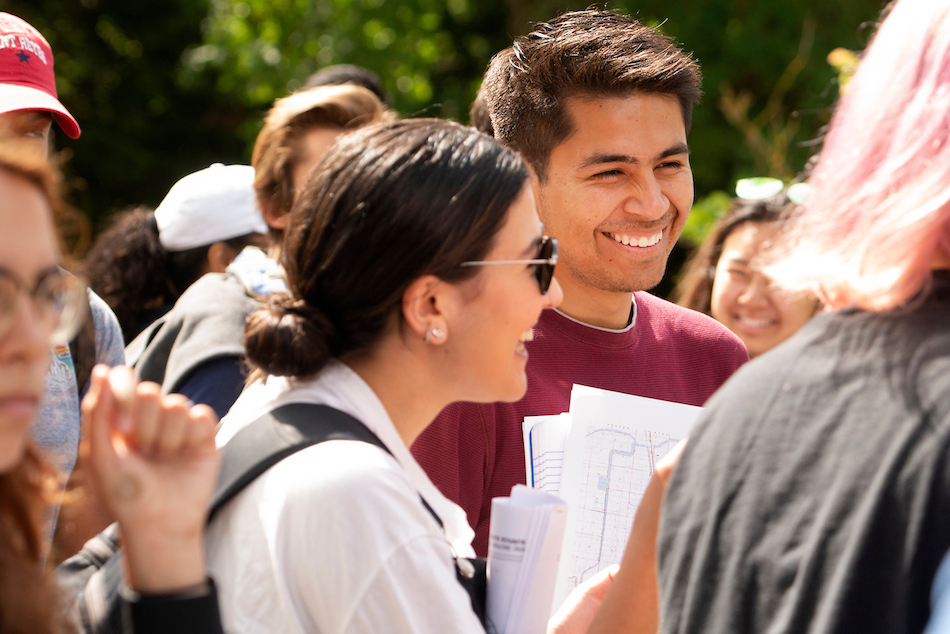 Students talk in the sunshine. 