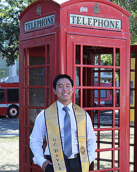 Communication major Chinsin Sim sitting on the UC Davis East Gate