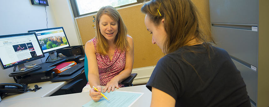 Two women going over information together in an office