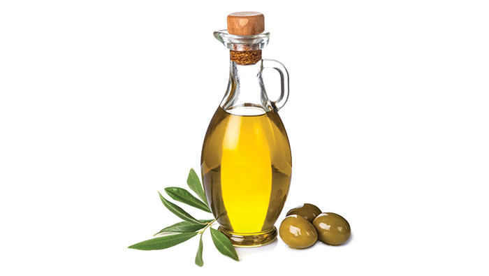 Bottle of oil, leaves and olives