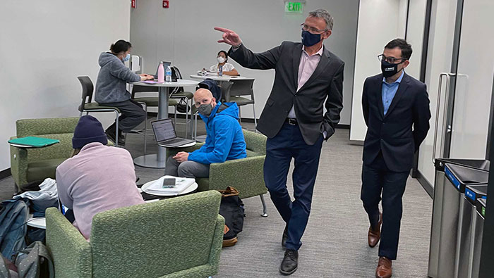 Law student Héctor Sánchez Castañeda walks through a study area with Dean Jean-Pierre Delplanque.