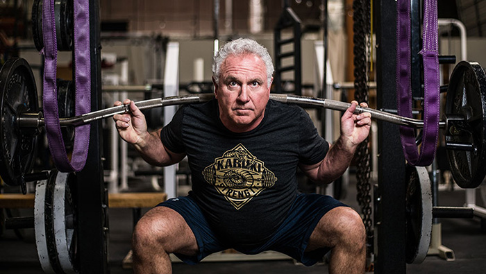 Rudy Kadlub lifts a barbell over his shoulders