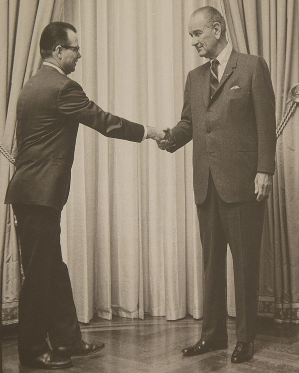 Two men shake hands