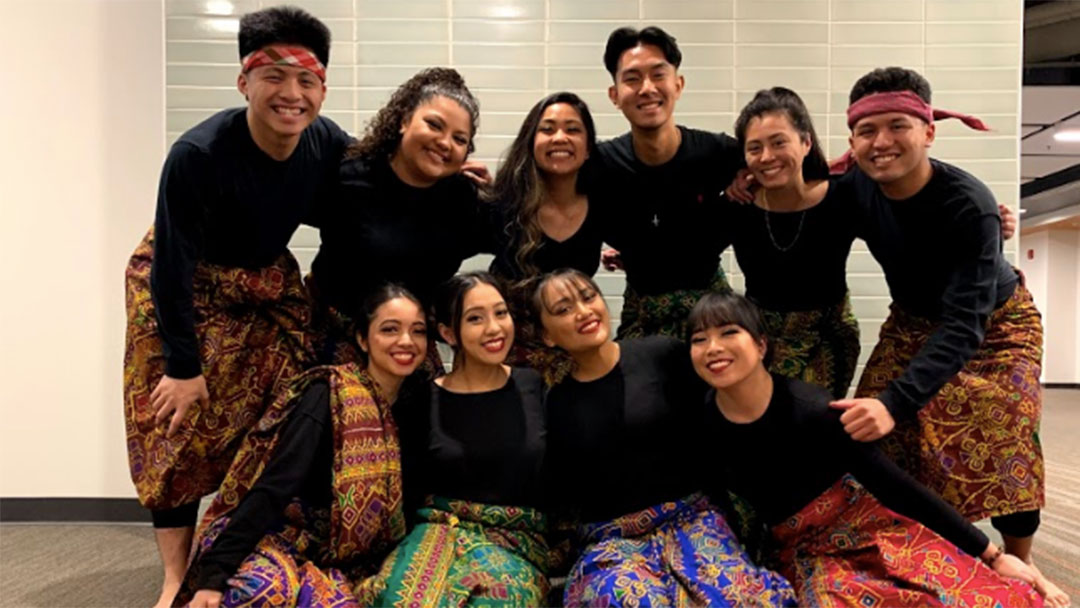 MK Vintage and MK Ensemble members pose together after a performance, wearing malongs, traditional Filipino garments often worn as skirts.