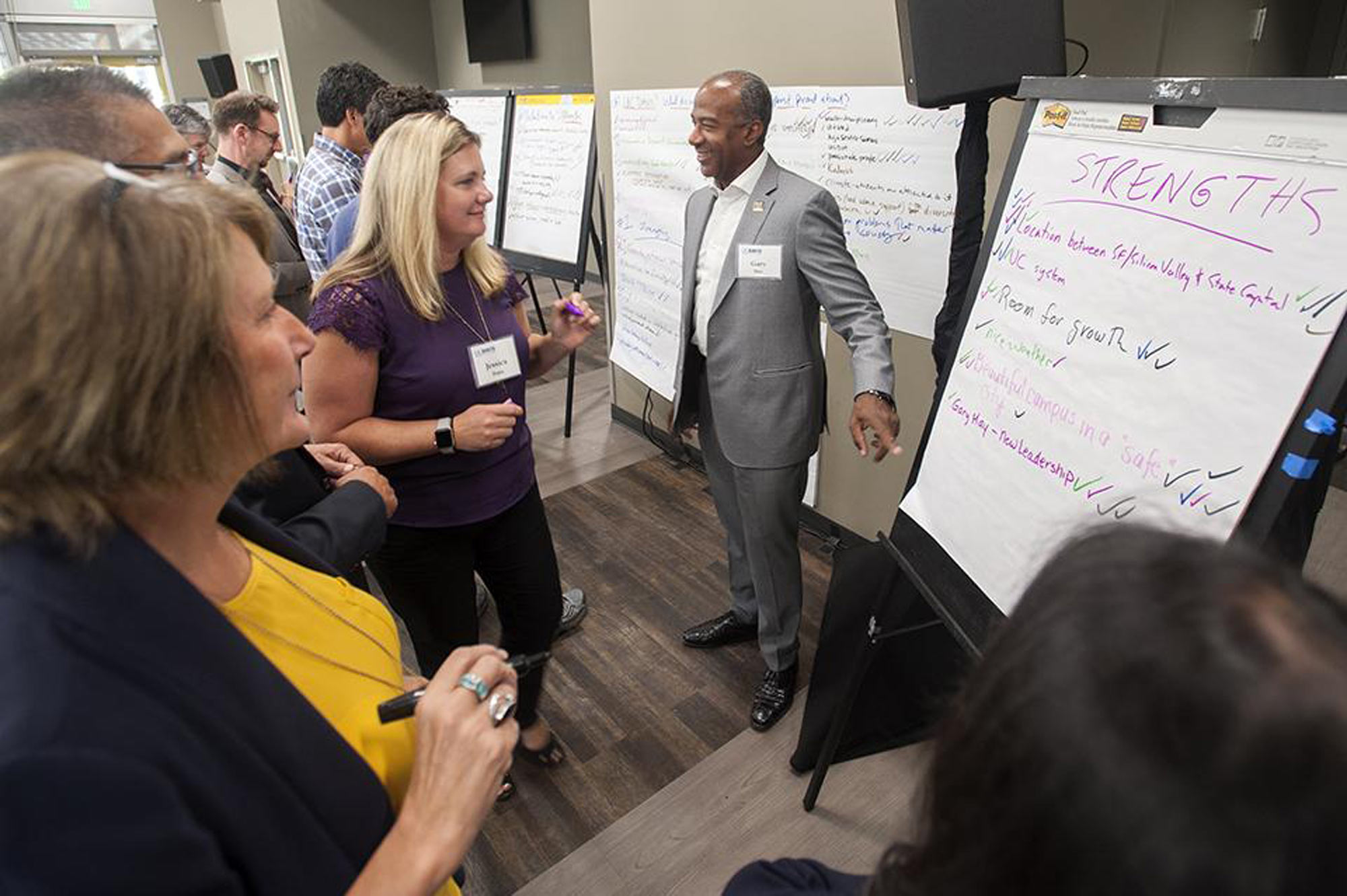 Executive in front of easels with pads of paper, for notes