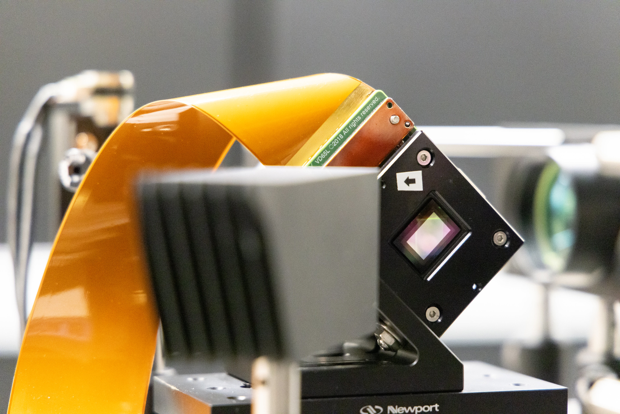 Electronic device with a ribbon cable coming out of it.