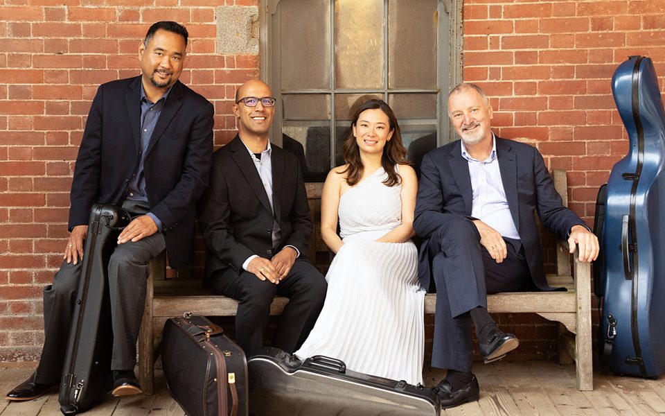 Musicians seated at bench