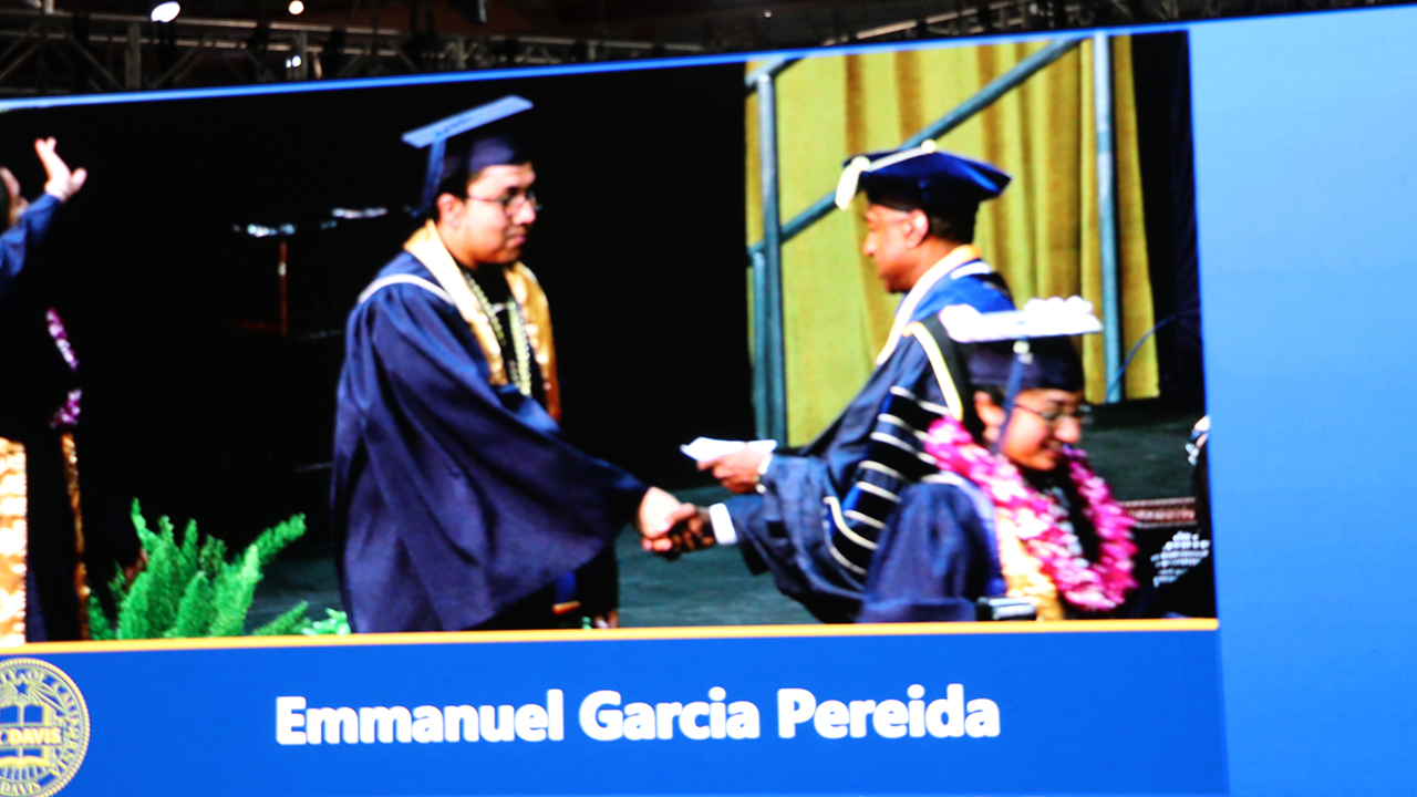 Pereida Garcia is shown on a large screen as he crosses the graduation stage. 