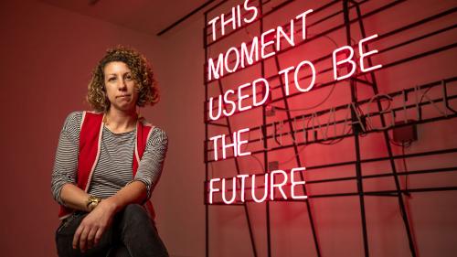 portrait of artist with neon sign