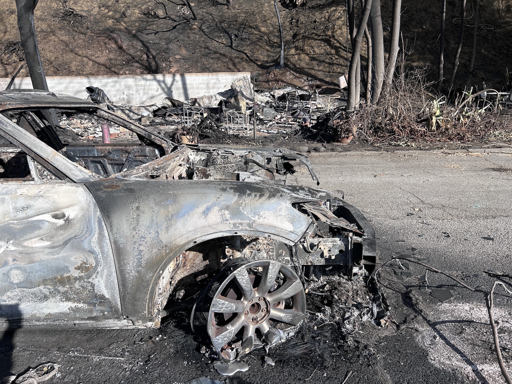 Are burned and smashed car sits among ashy remains of Eaton fire in January 2025