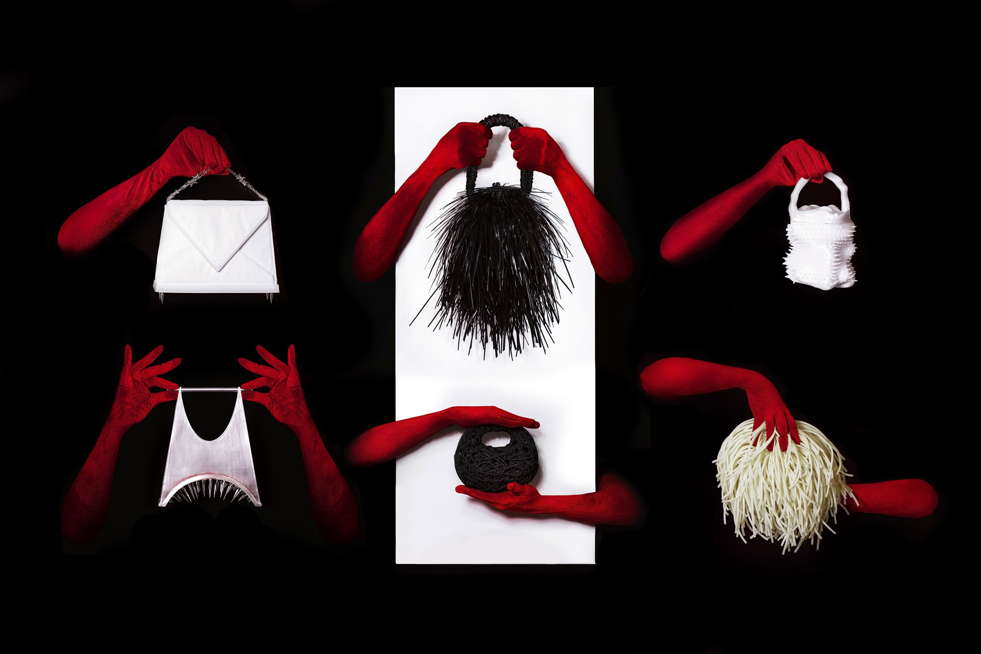 Red-gloved hands hold assorted wigs and masks on white panels against black background