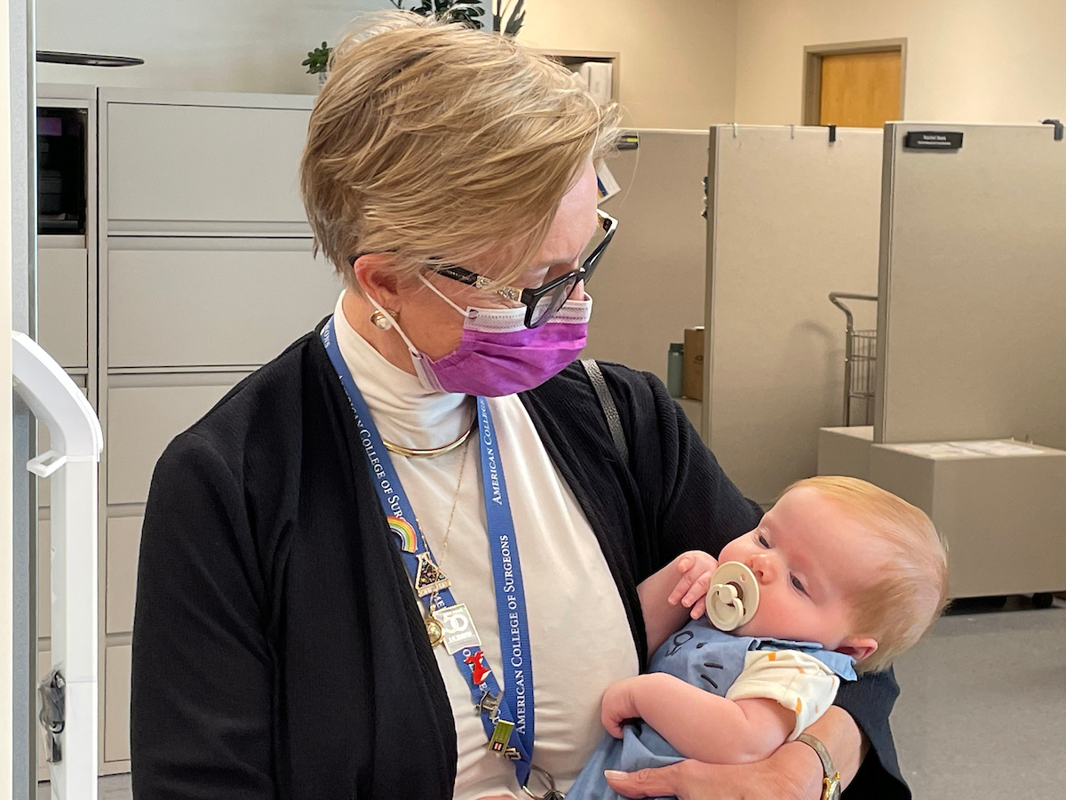 Pediatric surgeon Diana Farmer holds three-month-old Tobi Maginnis while he sleeps. Farmer performed the surgery and used stem cells to treat his spina bifida while he was in the womb.