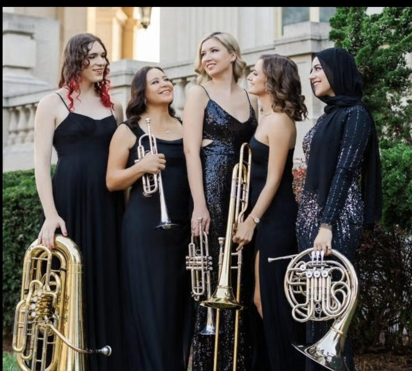Women dressed in black with instruments