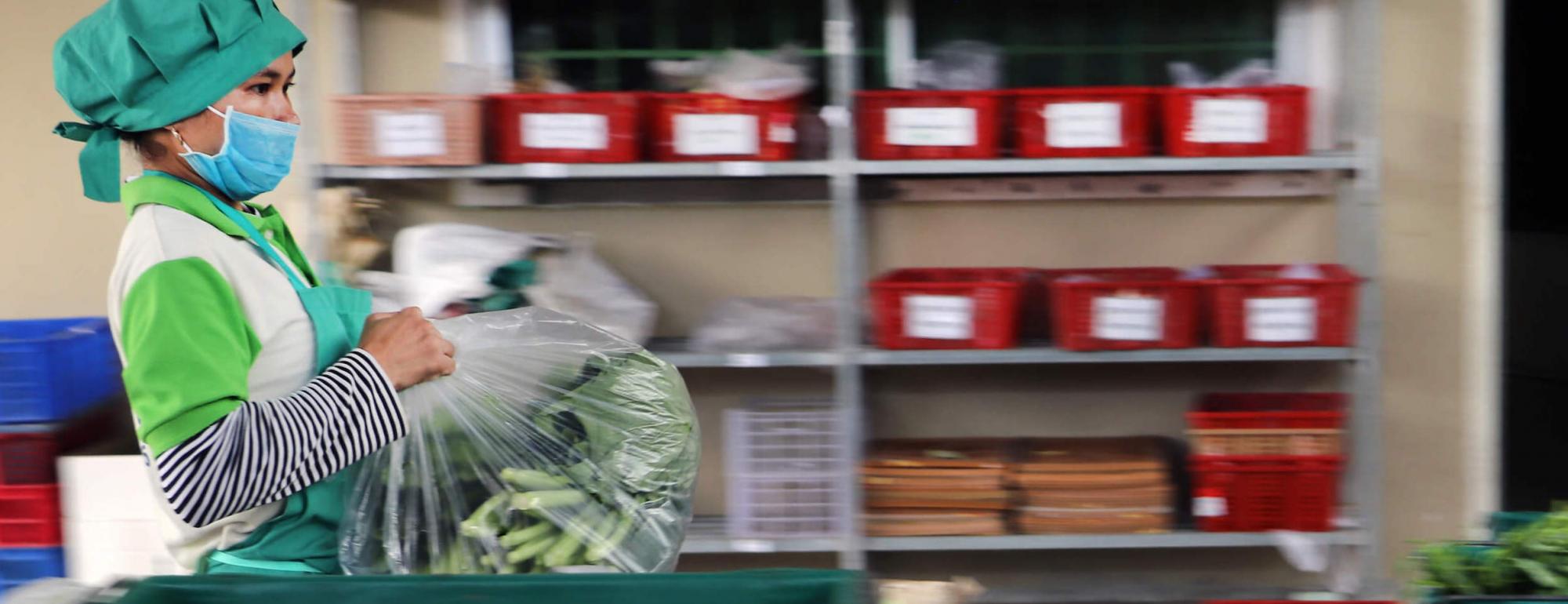 a worker repackaging food