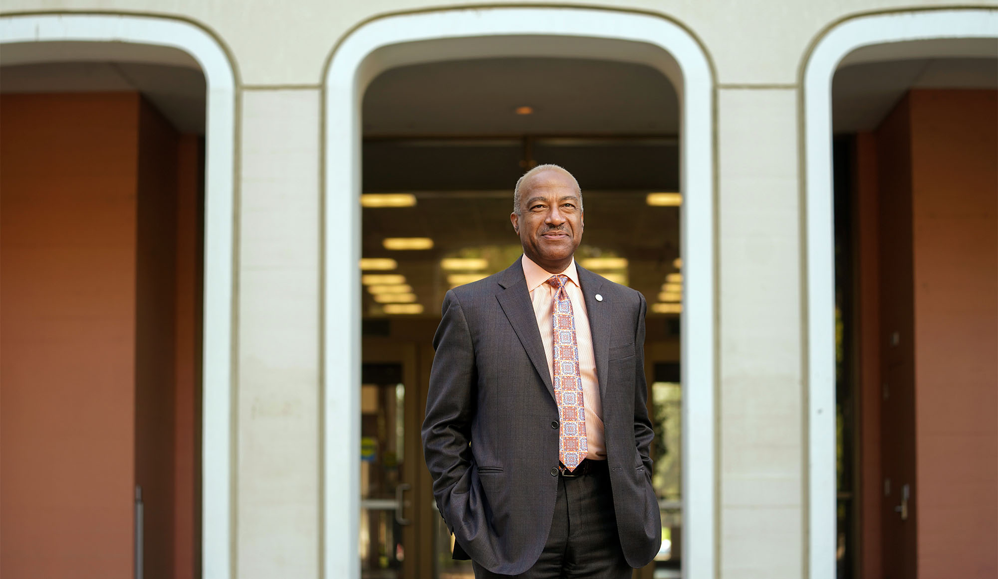 Chancellor Gary S. May poses for photo, hands in pockets, outside Mrak Hall.