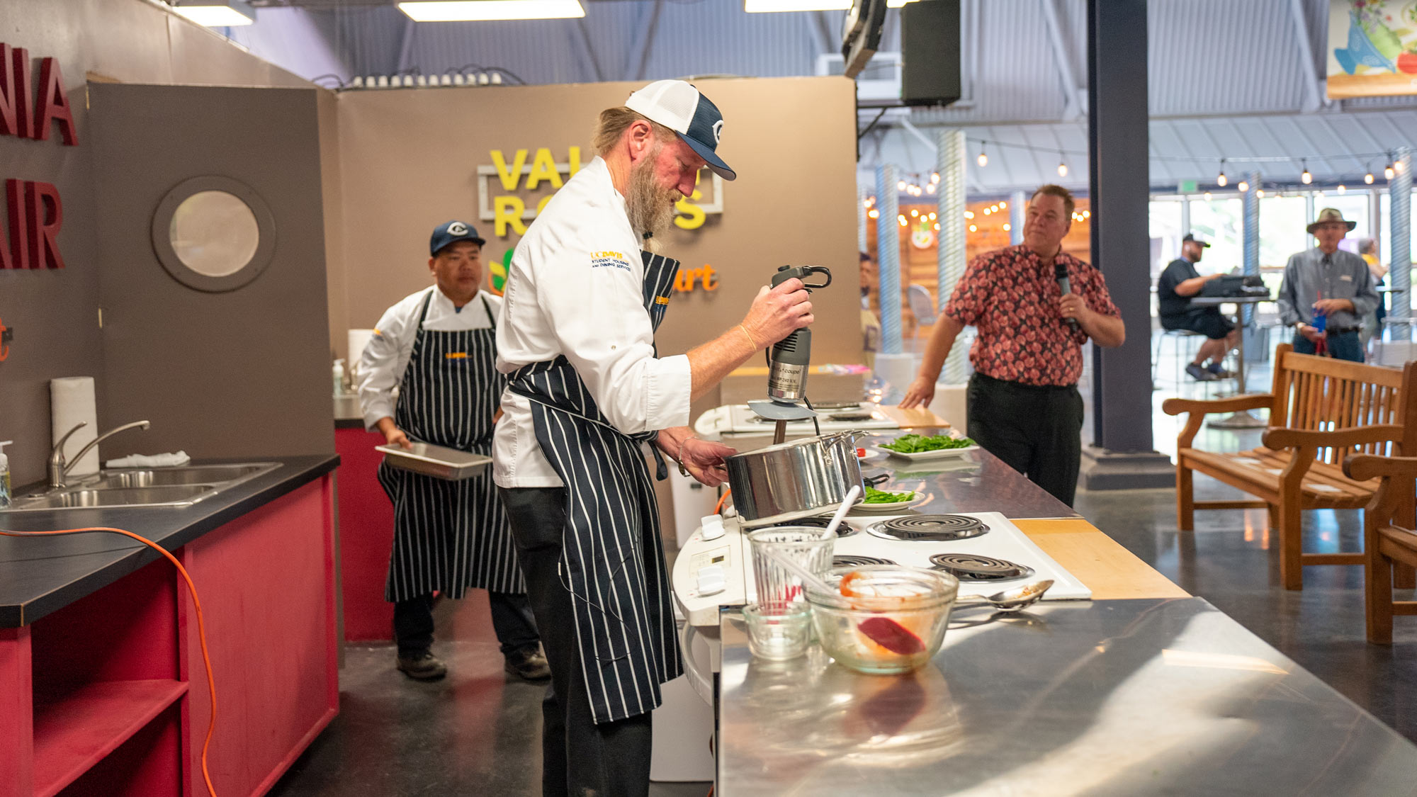 Chef uses electric mixer in pot