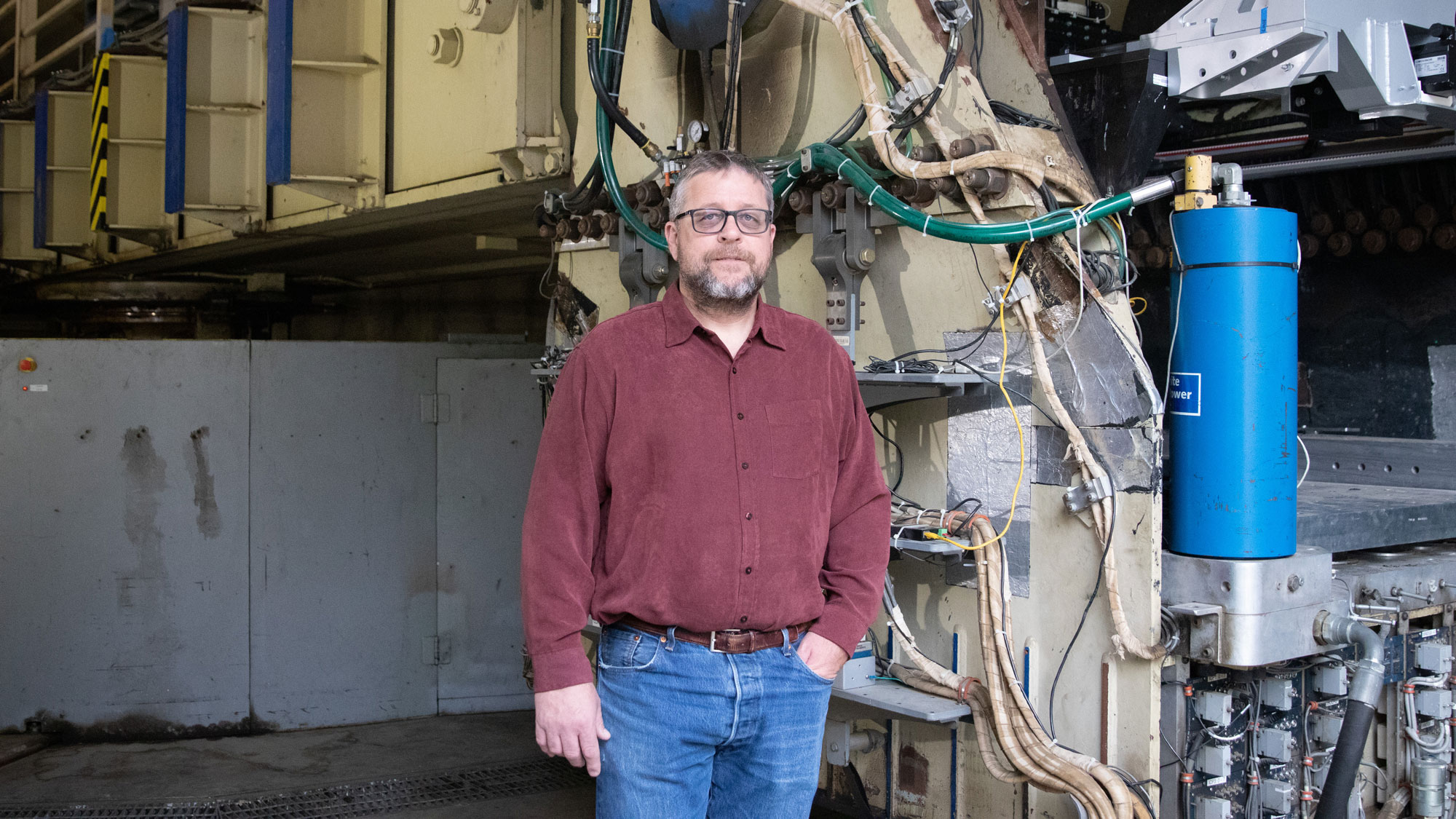 Daniel Wilson poses in front of world's largest centrifuge capable of simulating earthquake motions