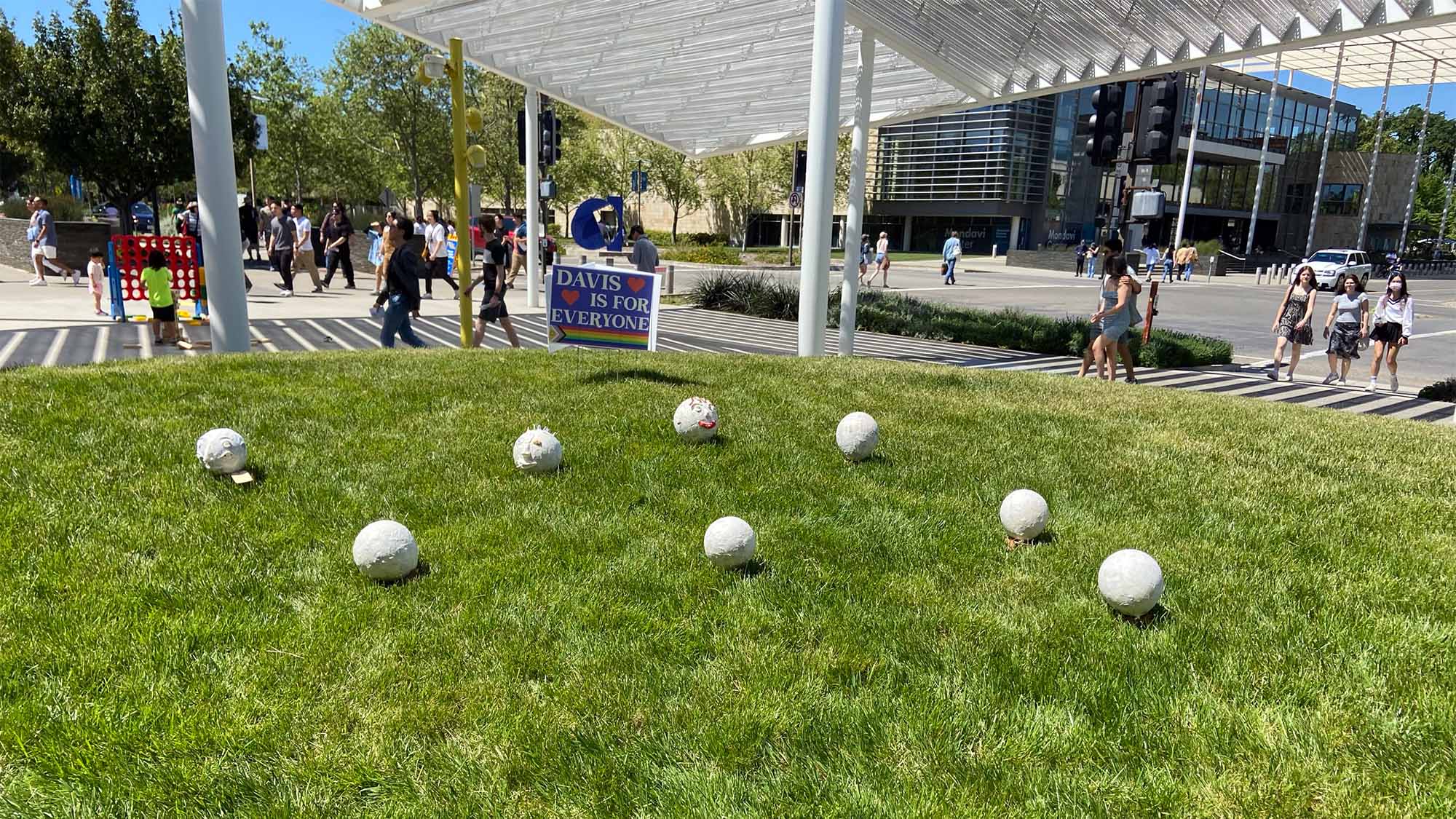 Egghead style papier-mâché creations on the grass