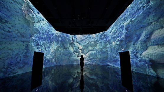 Photo of room with projected image of blue waves