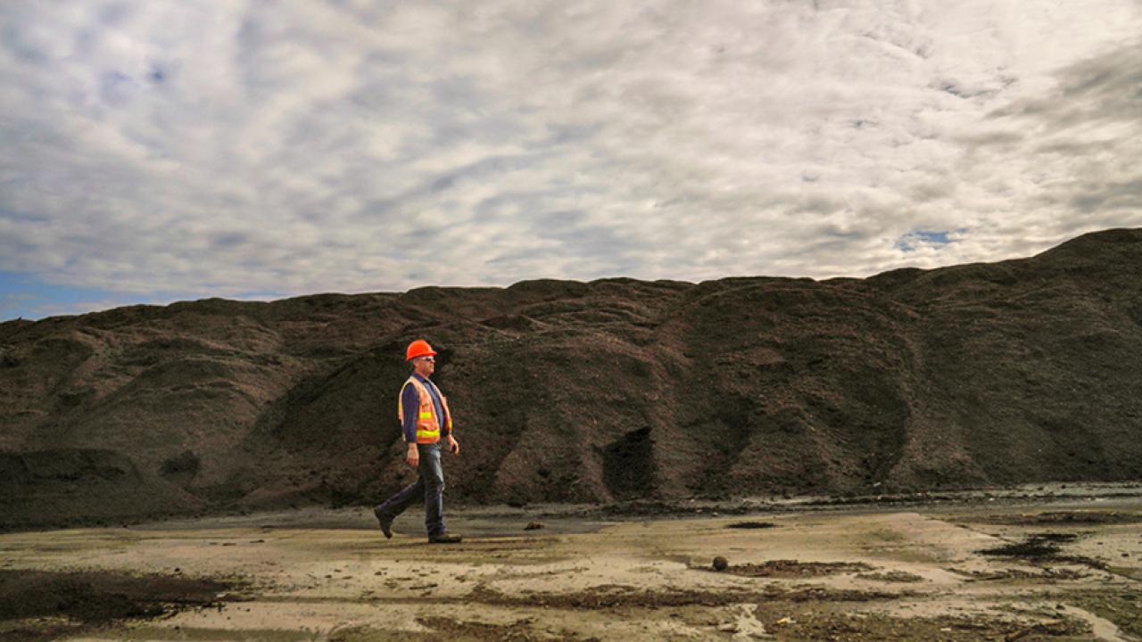 man walking in landfill