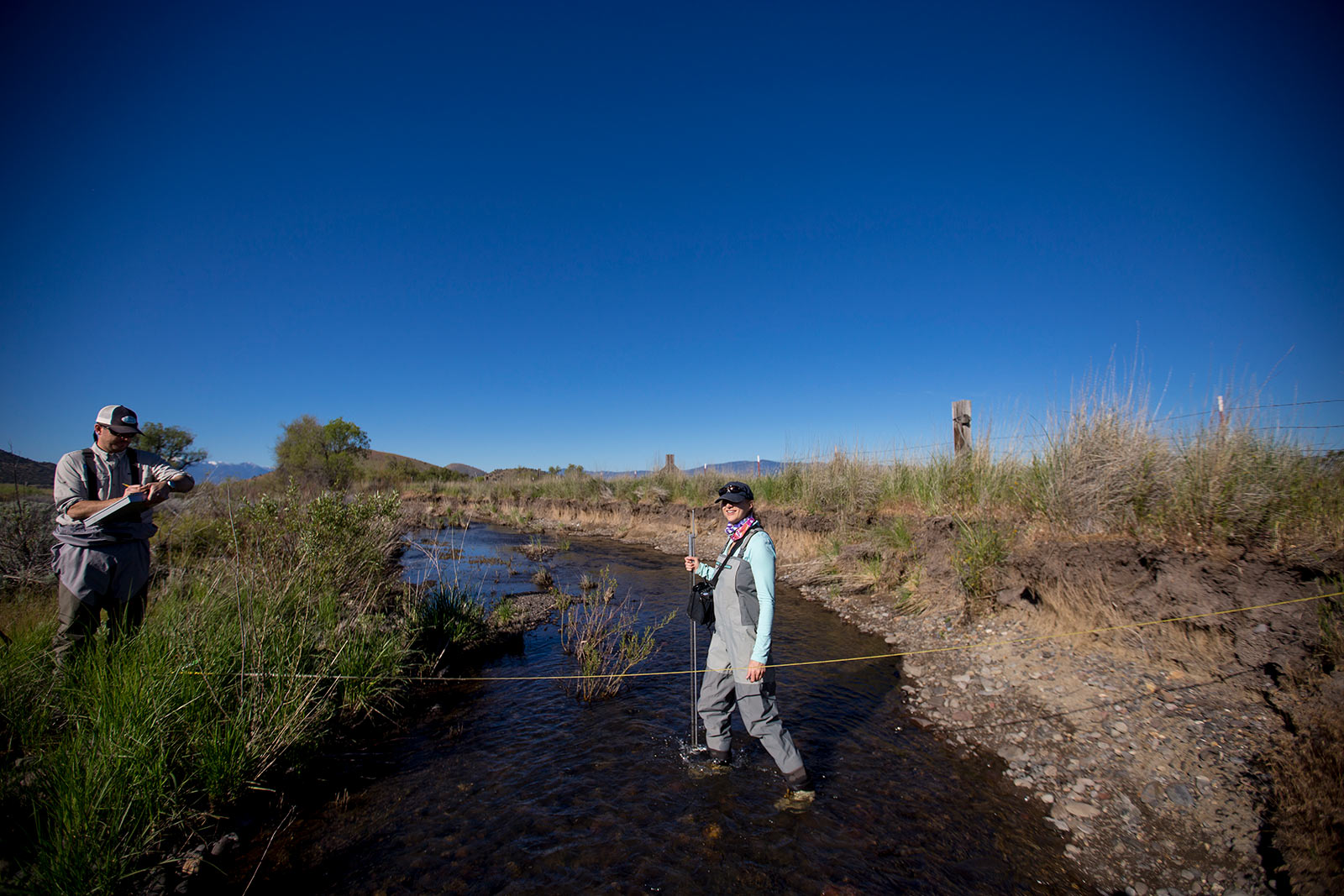 researchers measure river