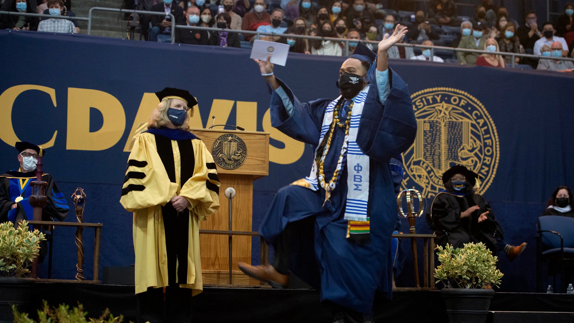 Graduate dances on stage.