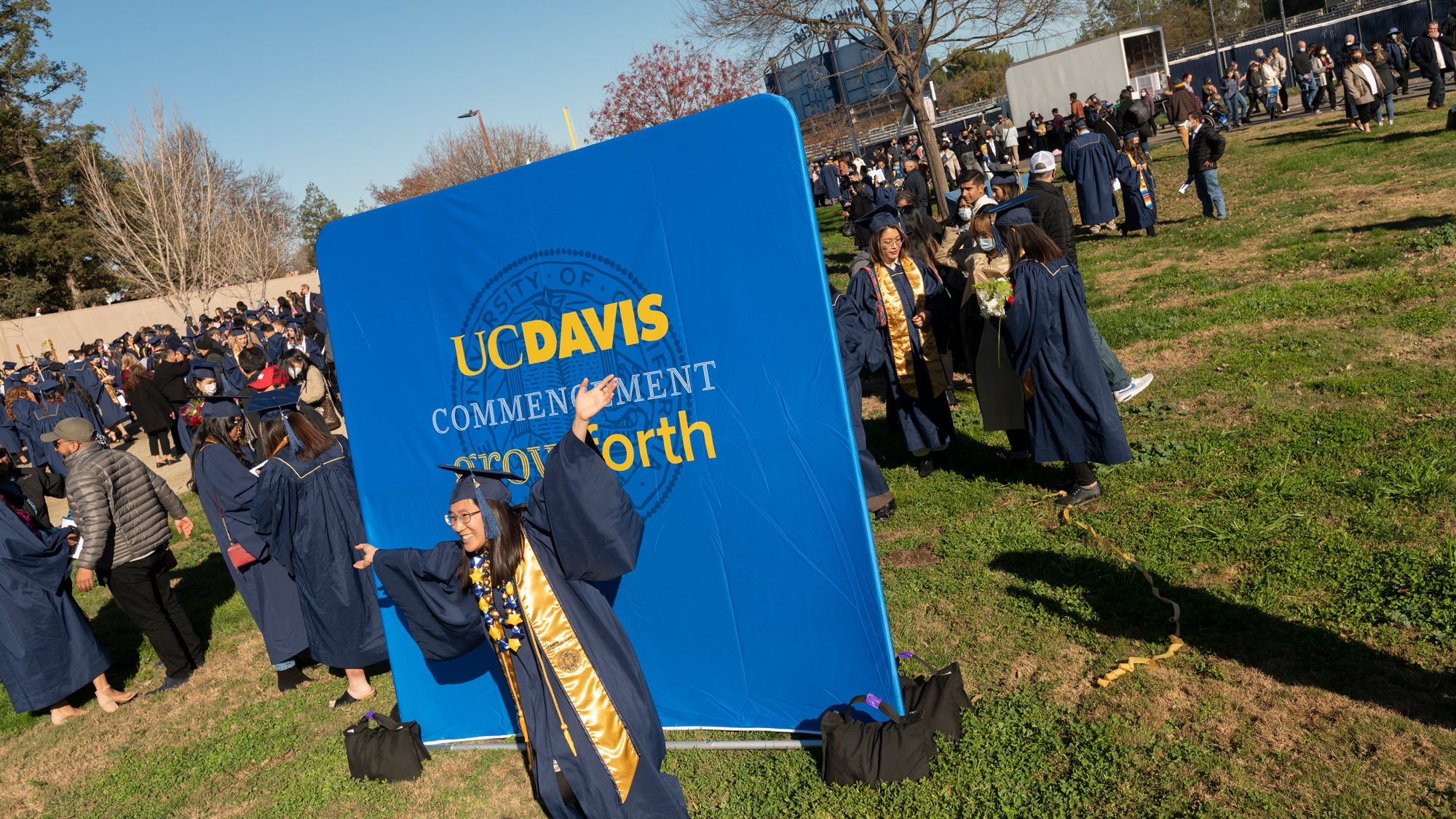 Student poses for photo before "Grow Forth" backdrop.