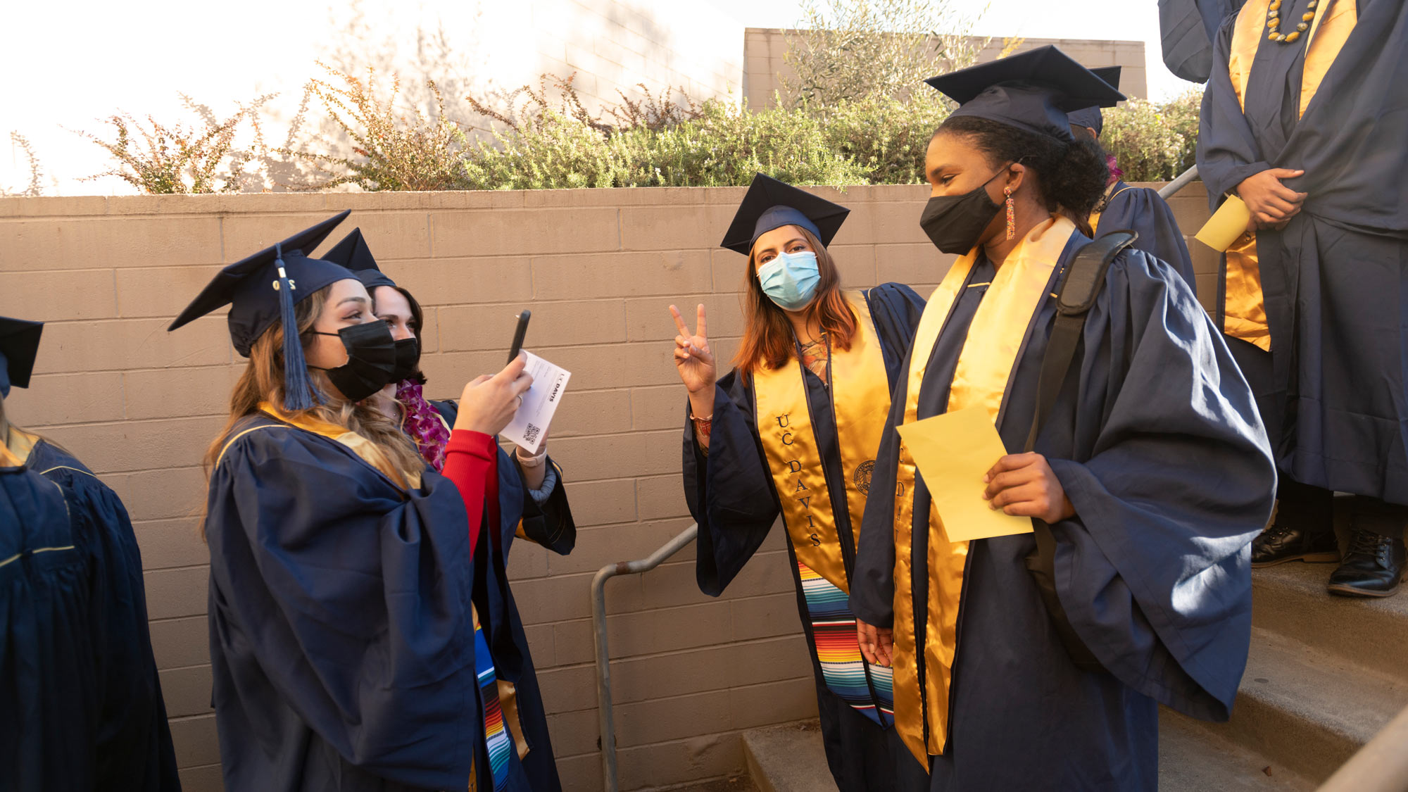 Students in commencement regalia gather for processional.