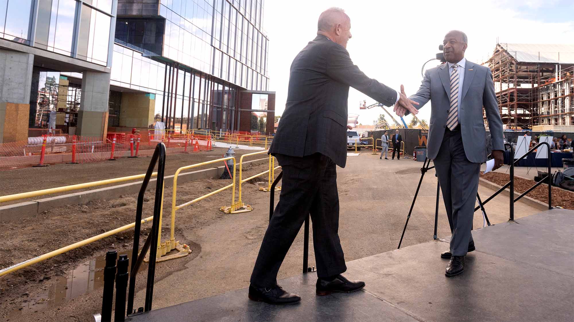 Gary S. May and Darrell Steinberg shake hands