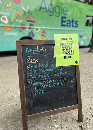 An A frame signs displays the AggieEats menu for the day