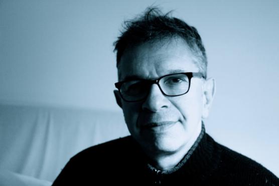 Portrait of man, wearing glasses, on neutral background