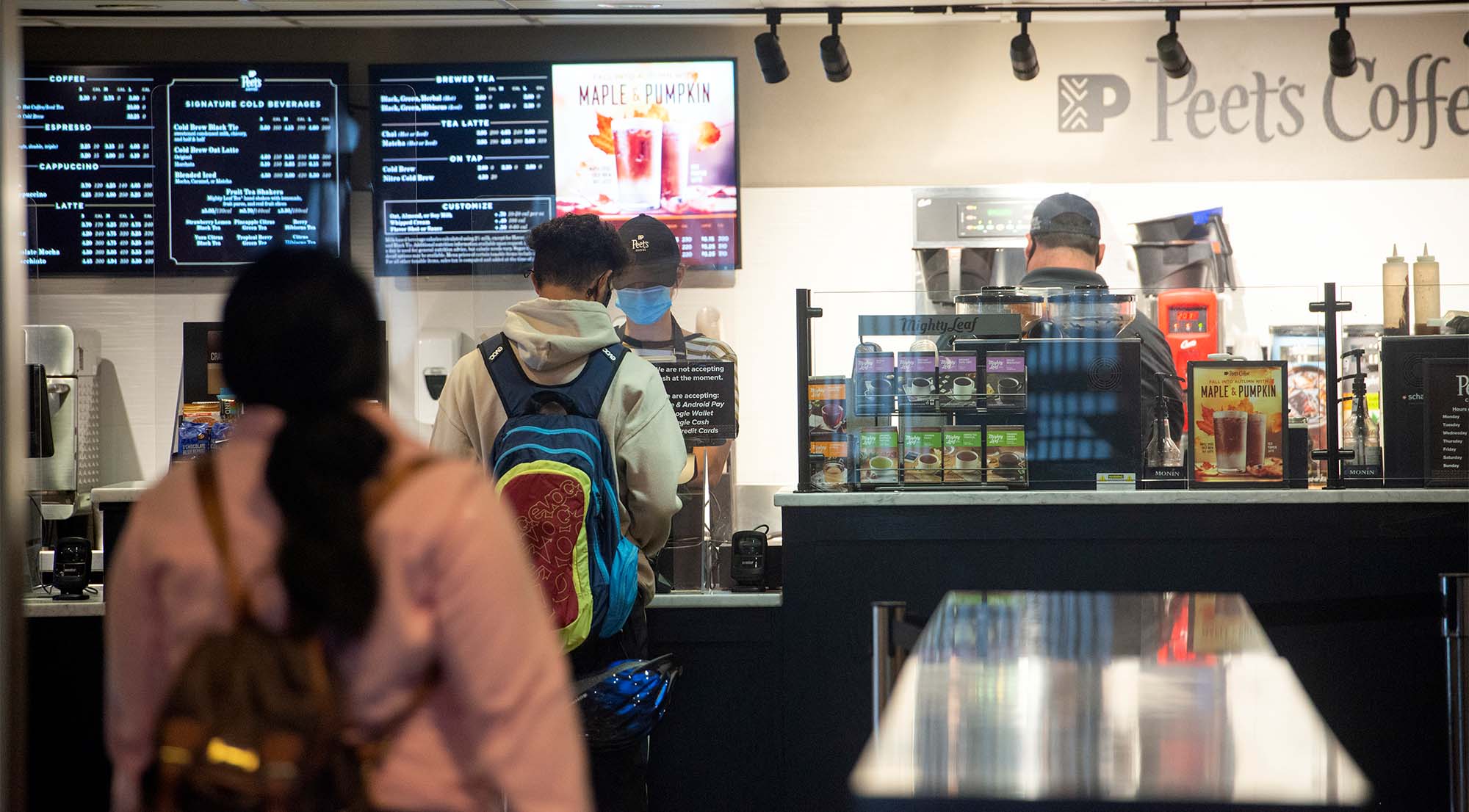 People wear face coverings as they order coffee at Peet's.