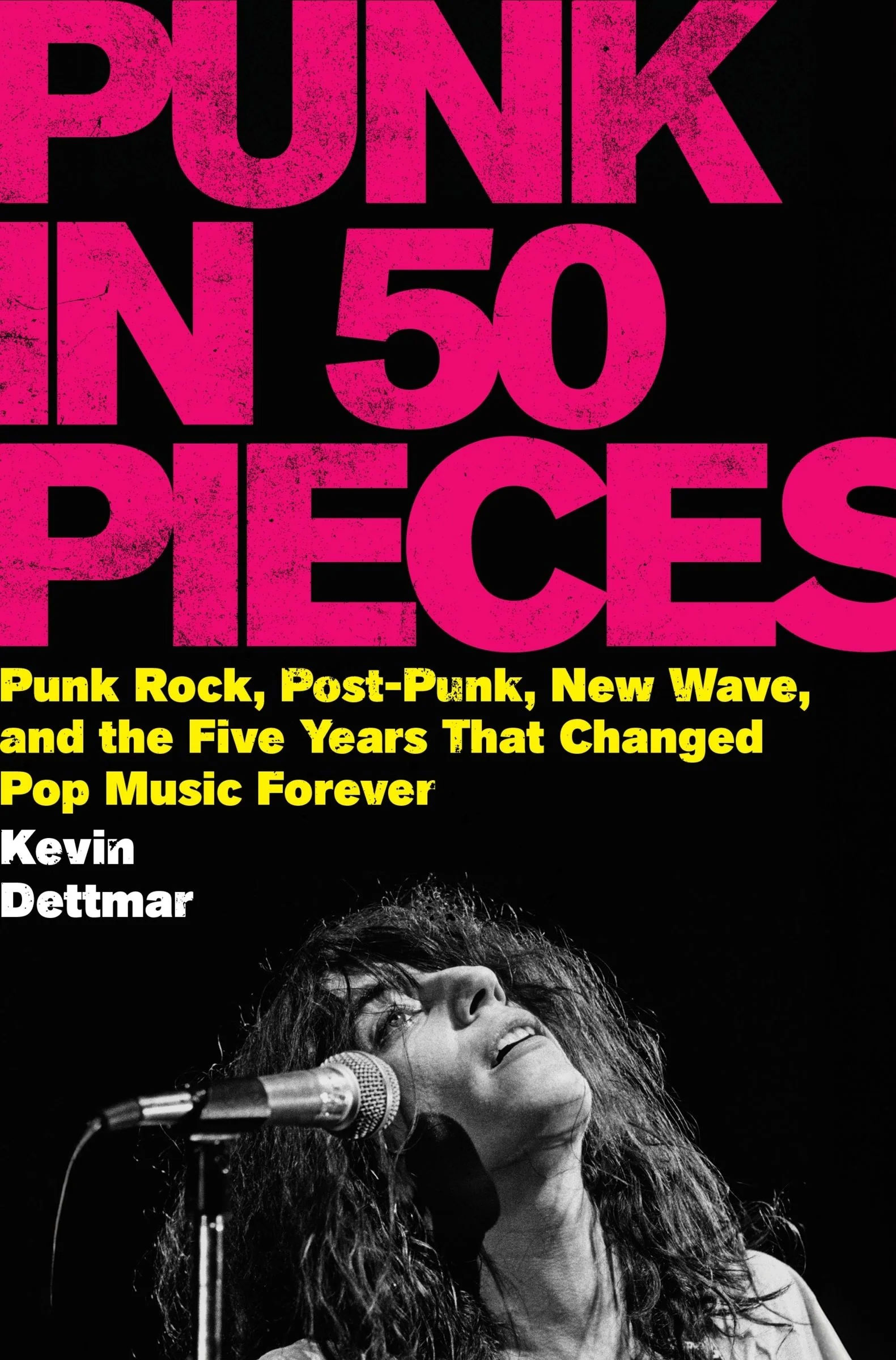 Book cover: bold pink 'PUNK IN 50 PIECES' on black; B/W singer photograph at microphone