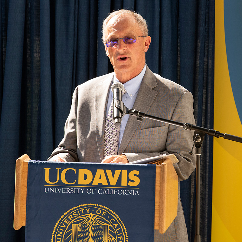 Photo of Ralph J Hexter speaking at lectern