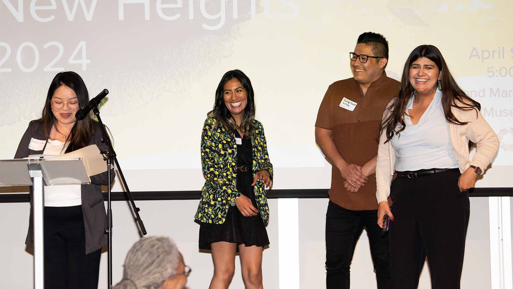 Group of people accepts award on stage