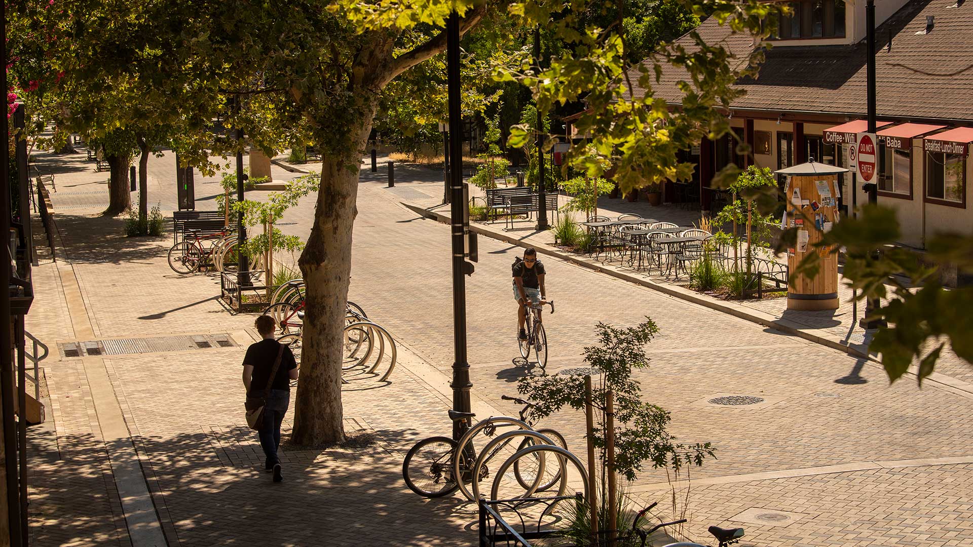 High angle photo of a street showing new brickwork in the street and wide sidewalks.