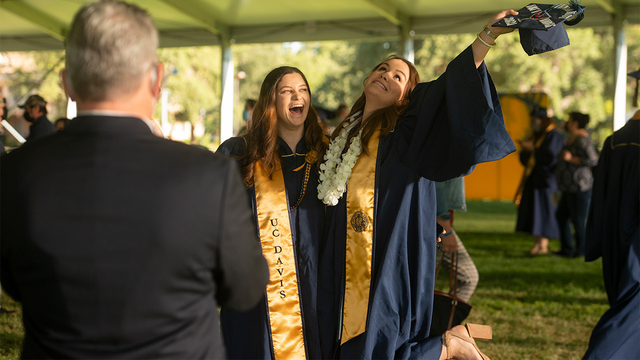 Students pose for a photo and laugh.