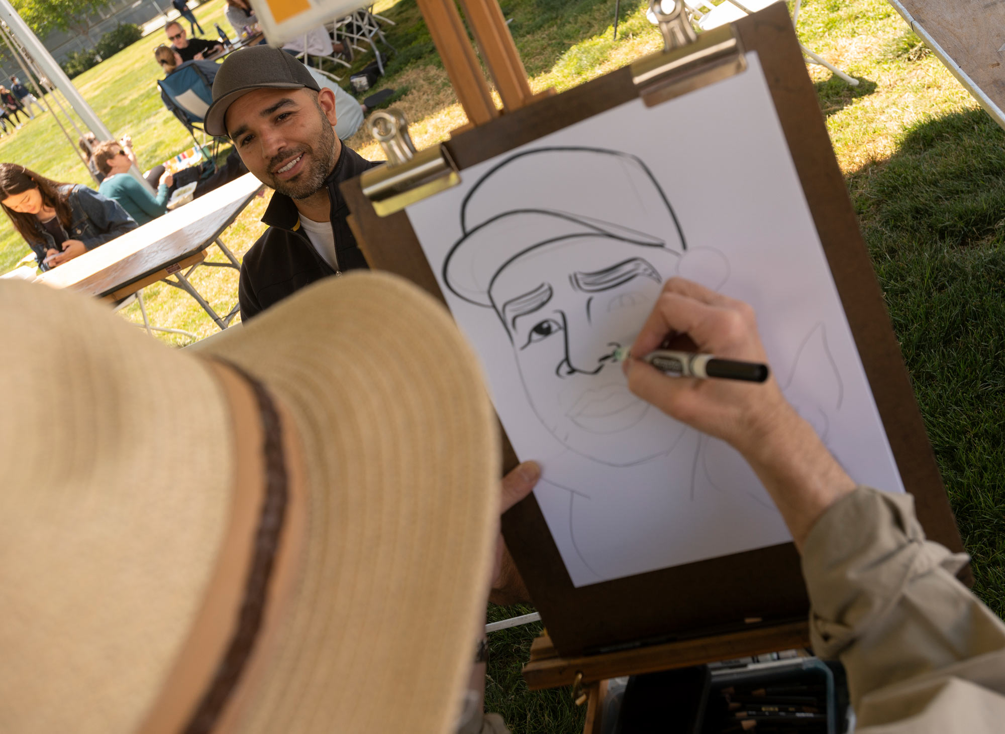 Artist draws caracature of a TGFS picnkicker