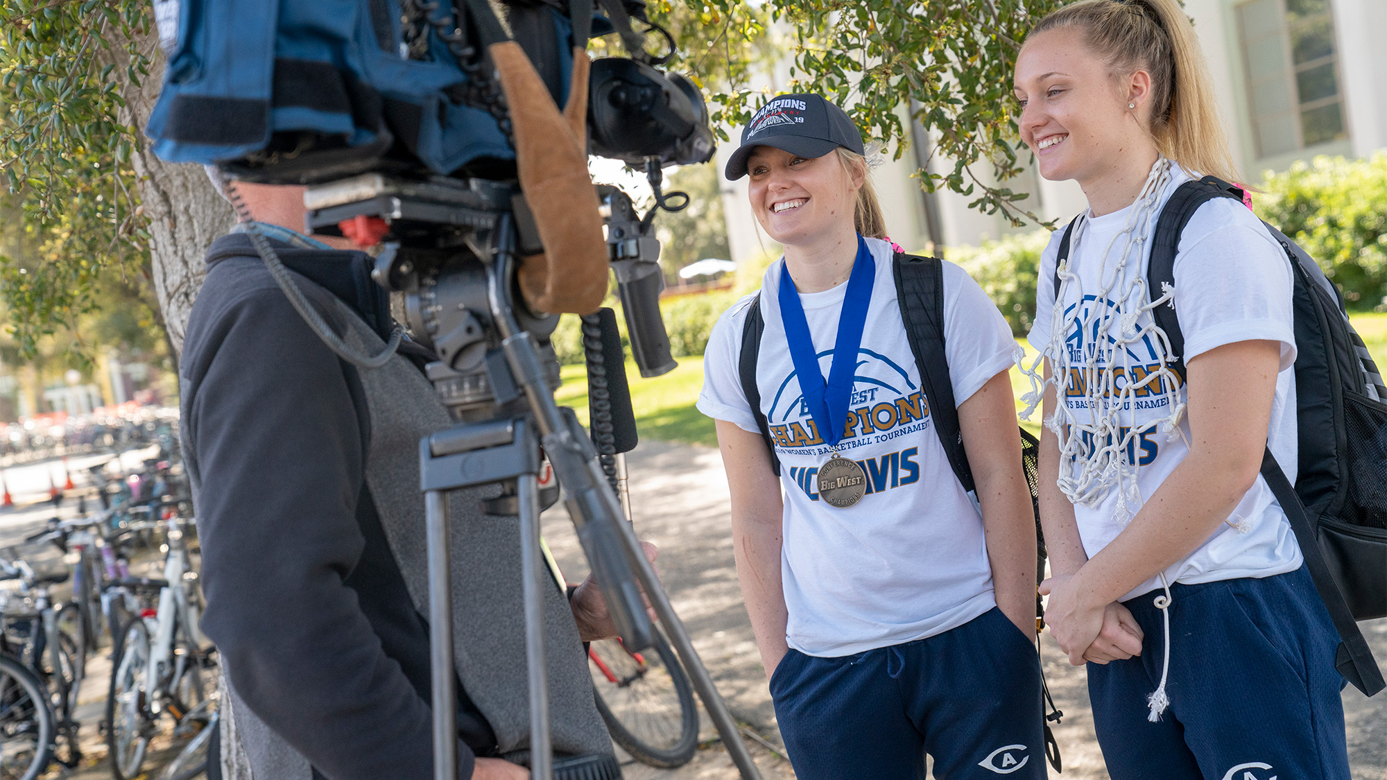 Basketball players interviewed by TV crew.