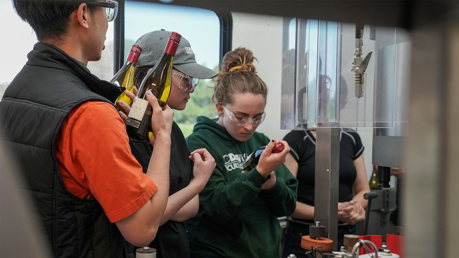 Students examine wine bottles during Halsey Bottling's demonstration. (Karin Higgins/UC Davis)