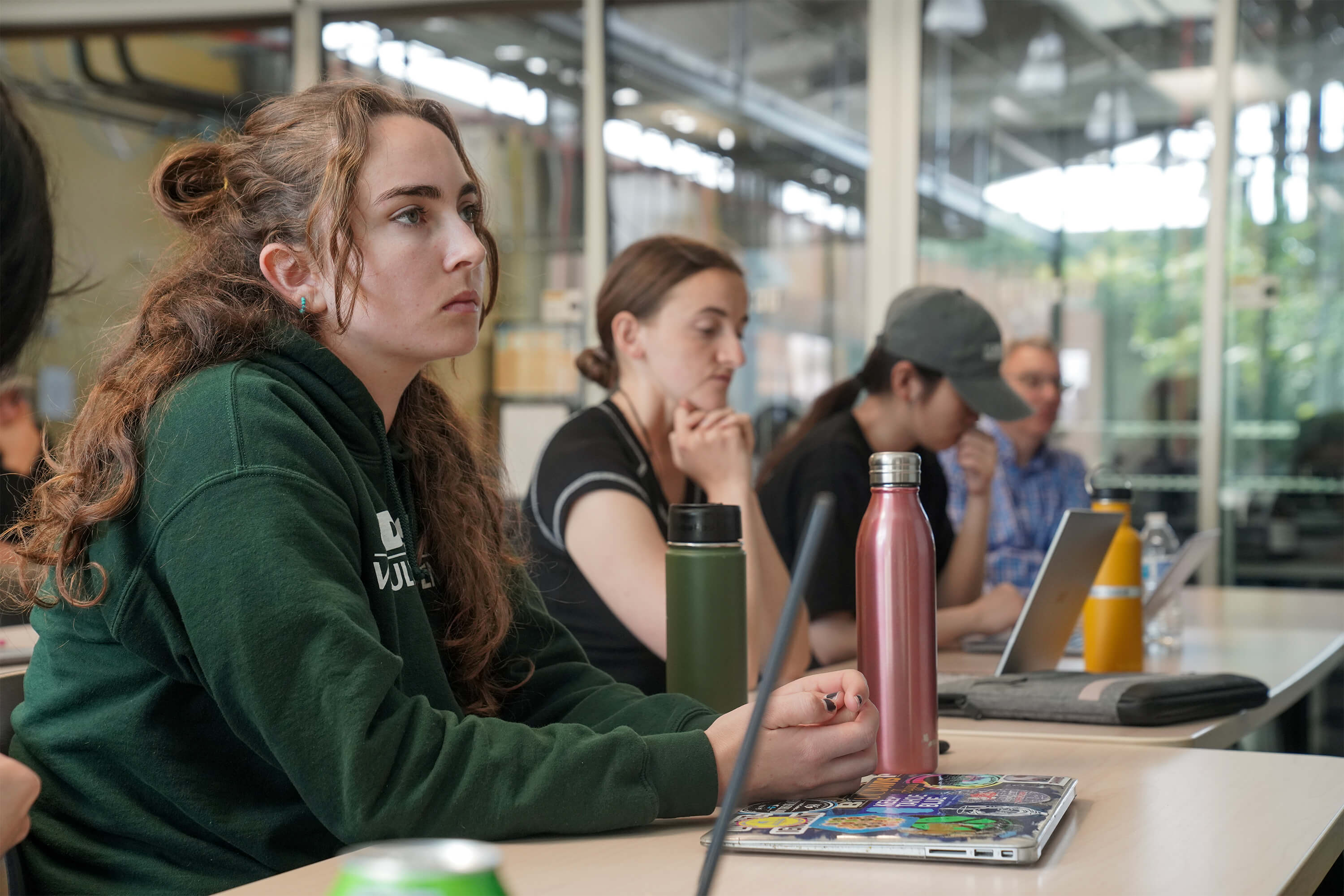 Students enrolled in VEN127L, a course in post-fermentation processing, sit in the classroom in the sustainable Teaching and Research Winery and attend to a wine industry guest presenter on May 25, 2023. (Karin Higgins/UC Davis)