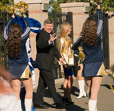 Dan Hawkins and his wife, Misti, enter Aggie Stadium.