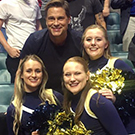 Rob Lowe poses for photo with UC Davis cheerleaders.