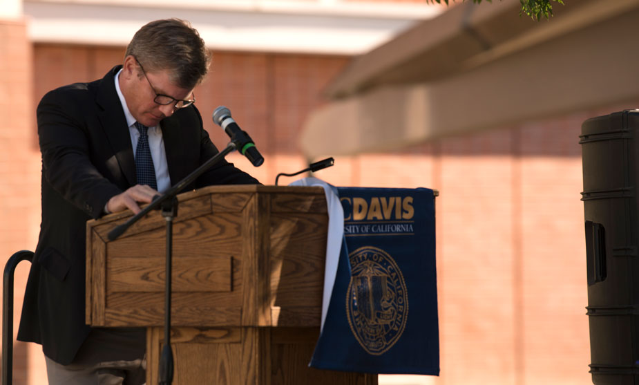 Man bows head at podium.