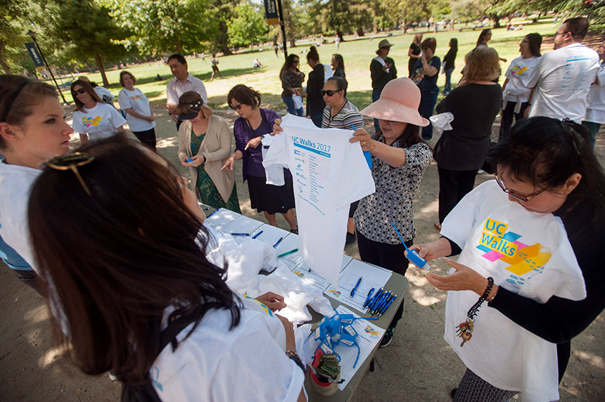 Staff members collect UC Walks shirts