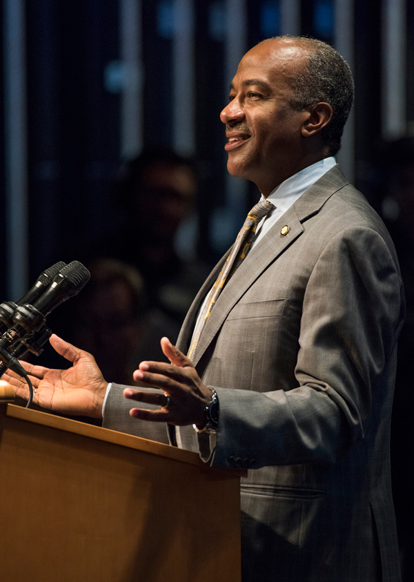 Chancellor May at podium, side view, showing his hands